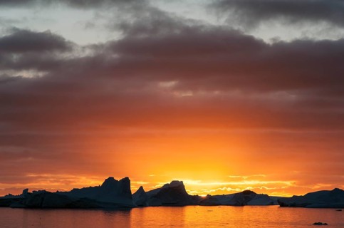 Sunset behind icebergs