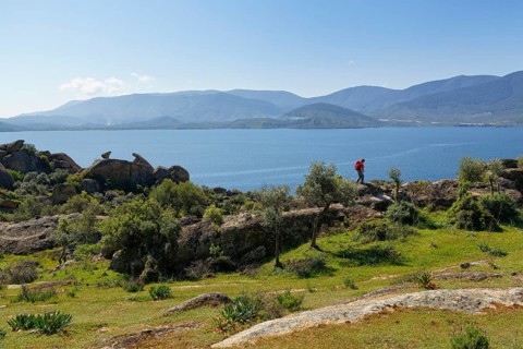 Woman wearing a backpack while hiking at Lake Bafa
