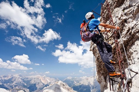 Climber ascending Monte Cristallo via the Via ferrata Ivano Dibona climbing route
