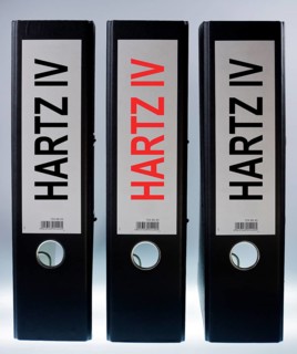 Three ring binders labeled Hartz IV