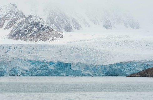 Glacial ice in the rocks surrounding a fjord