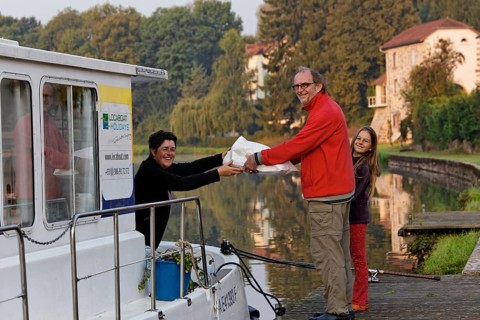 Father and daughter with brought bread in the early morning