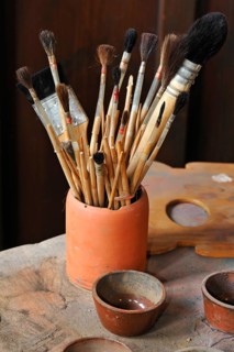 Various hair brushes in a cup