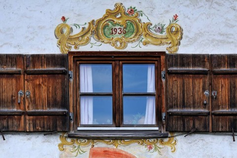 Window with shutters and Lueftlmalerei murals from 1936 on a farmhouse