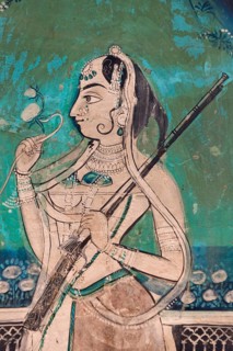 Woman holding a gun and a flower