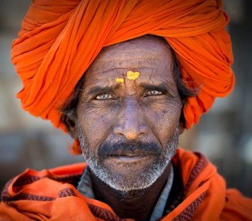 Man with and orange turban and yellow bindi on his forehead