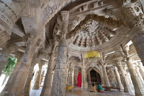 Women sitting in the Interior hall with ornate pillars and ceilings in the marble temple