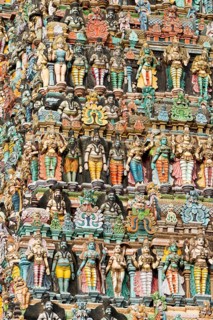 Colourful statues of gods and demons on the Gopuram or Gopura gate tower