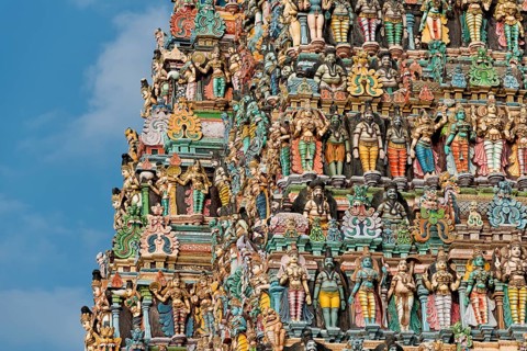 Colourful statues of gods and demons on the Gopuram or Gopura gate tower