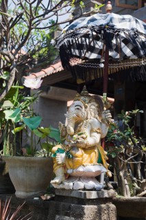 Stone figure of Ganesha with an umbrella