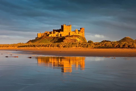 Bamburgh Castle and its reflection in the last light of the day
