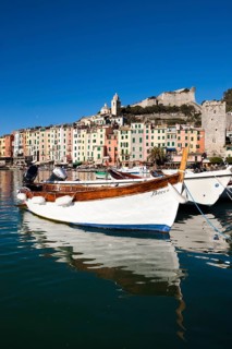 Fishing boats in the harbour in front of the historic town centre of Porto Venere
