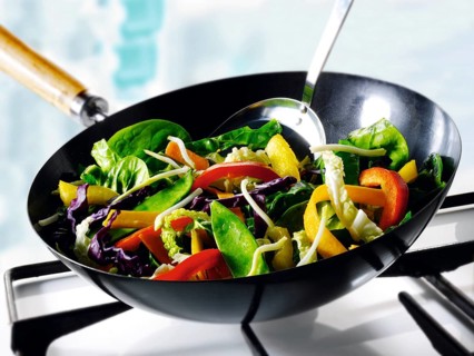 Vegetables being stirfried in a wok
