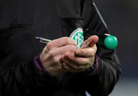 A German assistant refereee taking notes