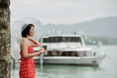 Woman with umbrella outside in a summer rain
