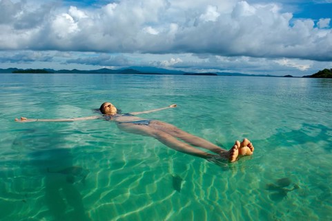 Tourist floating in the clear water of the Marovo Lagoon