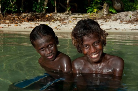 Smiling local boys in the water of the Marovo Lagoon