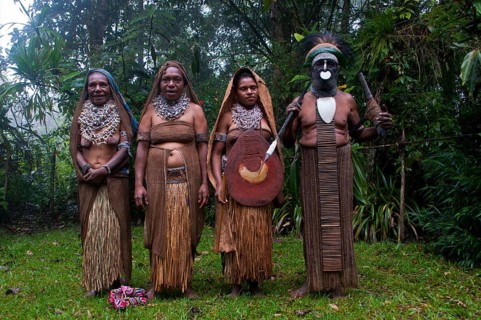 Tribal chief and three women wearing traditional dresses