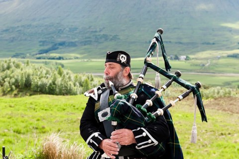 Bagpiper in the Scottish Highlands