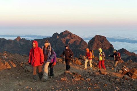 Group of hikers on a hiking trail just before the summit of Piton des Neiges Mountain
