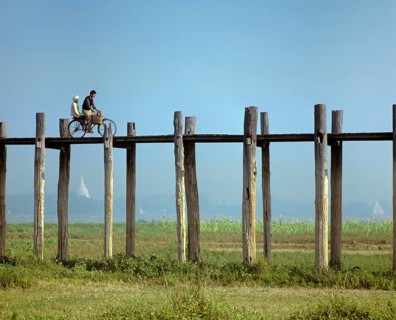 Cyclist on a teak bridge