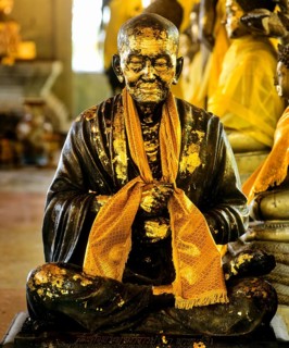 Gilded monk statue in the mountain temple of Wat Phra That Doi Tung