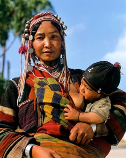 Young Akha woman breastfeeding baby
