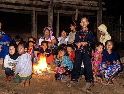 Lahu children sitting around a campfire in a mountain village