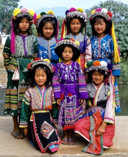 A group of Lisu hill tribe girls wearing traditional costumes and headdresses