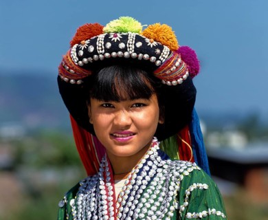 Lisu girl wearing a colourful headdress and the traditional costume of the mountain people