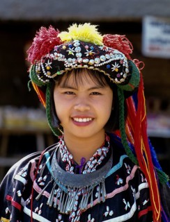 Lisu girl wearing a colourful headdress and the traditional costume of the mountain people