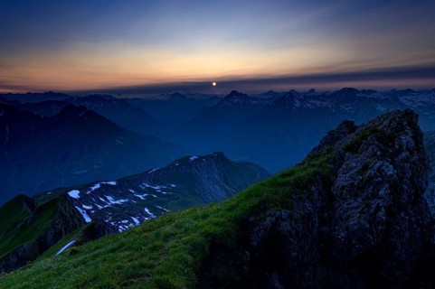 Mountain pasture at sunset with a panoramic view of the mountains