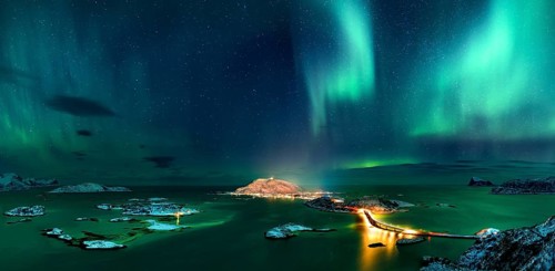 Fjord with islands in winter and the northern lights