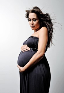 Woman with a pregnant belly wearing a dress