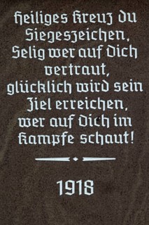 Religious inscription on the base of a wayside cross