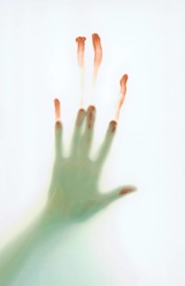 Bloodied hand slipping down frosted glass