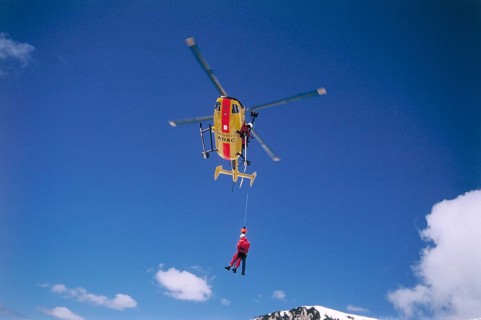 ADAC helicopter during a mountain rescue with a winch