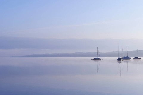 Lake Starnberg with sailing boats in the morning