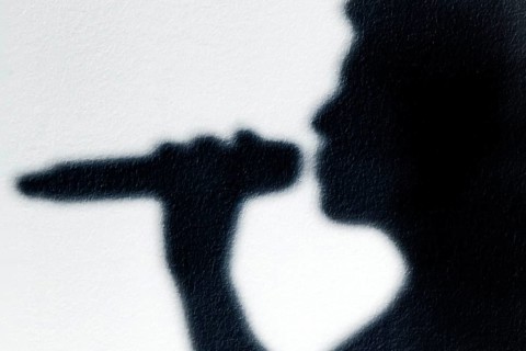 Shadow of a singer with microphone