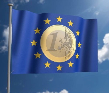 Euro coin on EU Flag