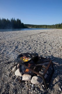 cooking / frying bacon and eggs on a camp fire