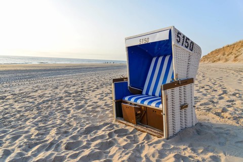 Roofed wicker beach chair on the beach