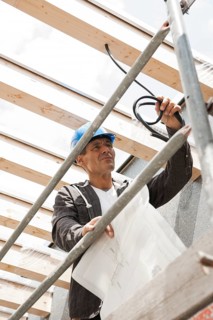 Construction manager controlling the electrical wiring on a construction site