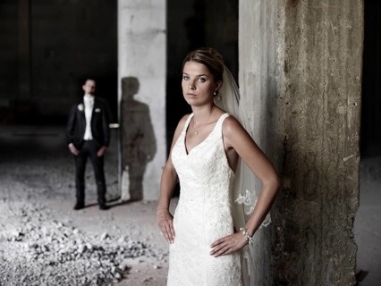 Bridal couple standing in an old industrial hall
