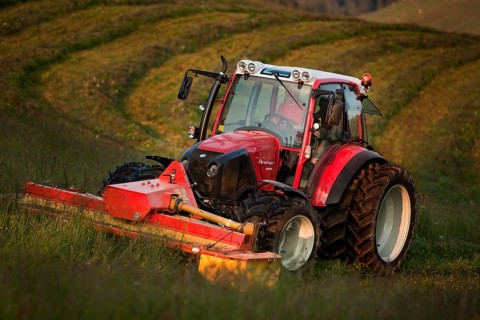 Tractor mowing hay