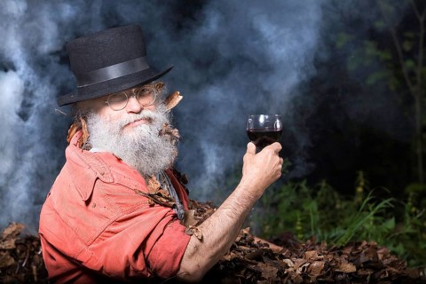 Elderly man with a long beard wearing a top hat and glasses