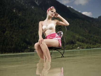 Woman sitting on a chair in the water