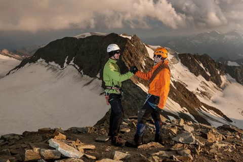 Mountain climbers congratulating one another following the ascent to the summit of Wilder Pfaff Mountain