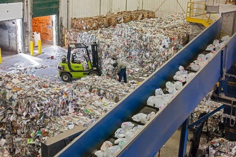 Low-wage workers sort paper