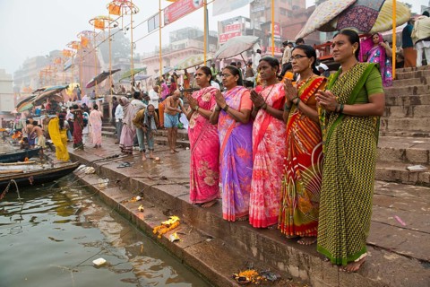 Five women in colorful saris in prayer
